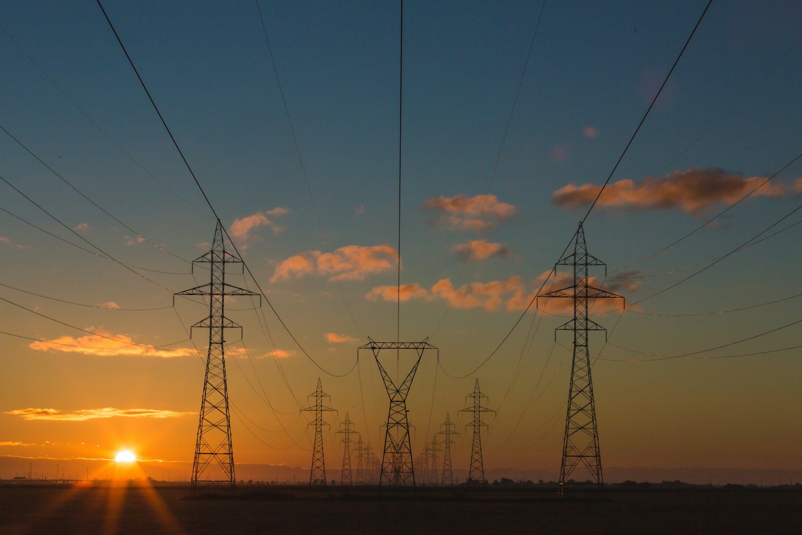 High-voltage transmission towers carrying power across the landscape